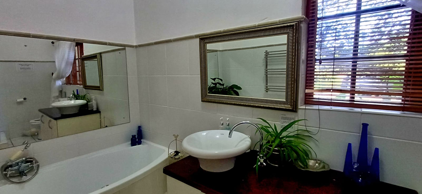 Bath and basin in the Lemon Balm Suite bathroom